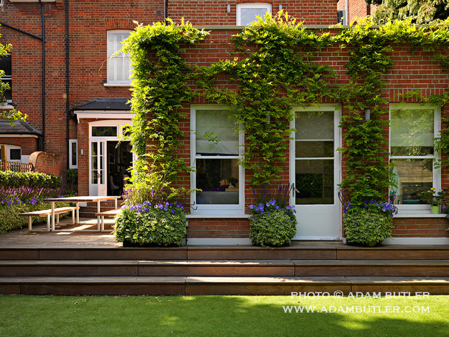 Design ideas for a medium sized contemporary back patio in London with decking.