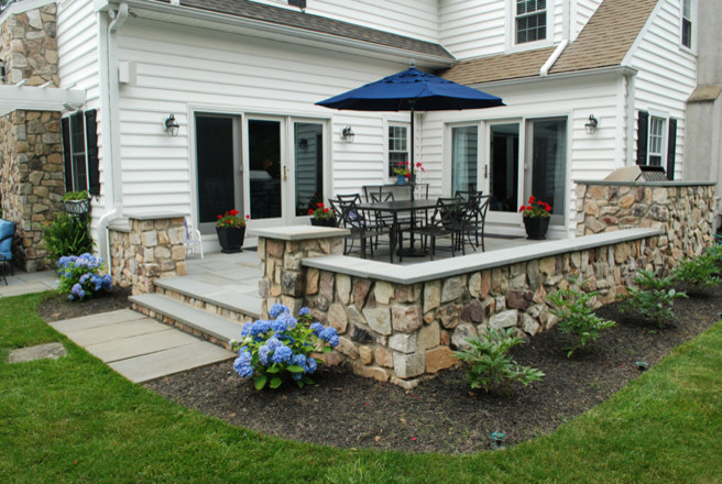 Inspiration for a small classic back patio in Philadelphia with an outdoor kitchen, natural stone paving and no cover.