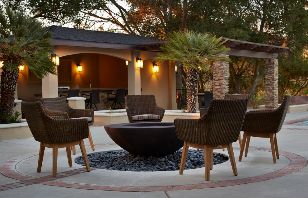 Imagen de patio clásico renovado sin cubierta en patio trasero con brasero y losas de hormigón