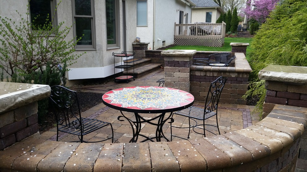 Inspiration for a mid-sized timeless backyard concrete paver patio remodel in Columbus with no cover