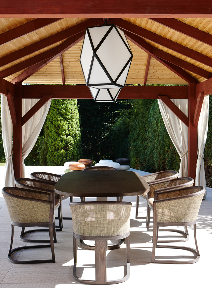 Design ideas for a medium sized classic back patio in London with tiled flooring and a gazebo.