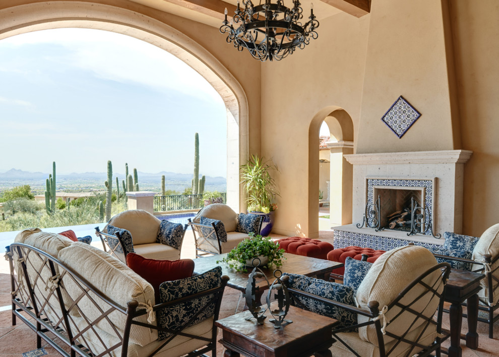 Large tuscan backyard patio photo in Phoenix with a fireplace and a roof extension