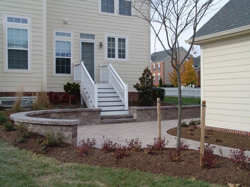 This is an example of a small classic back patio in Baltimore with concrete paving.