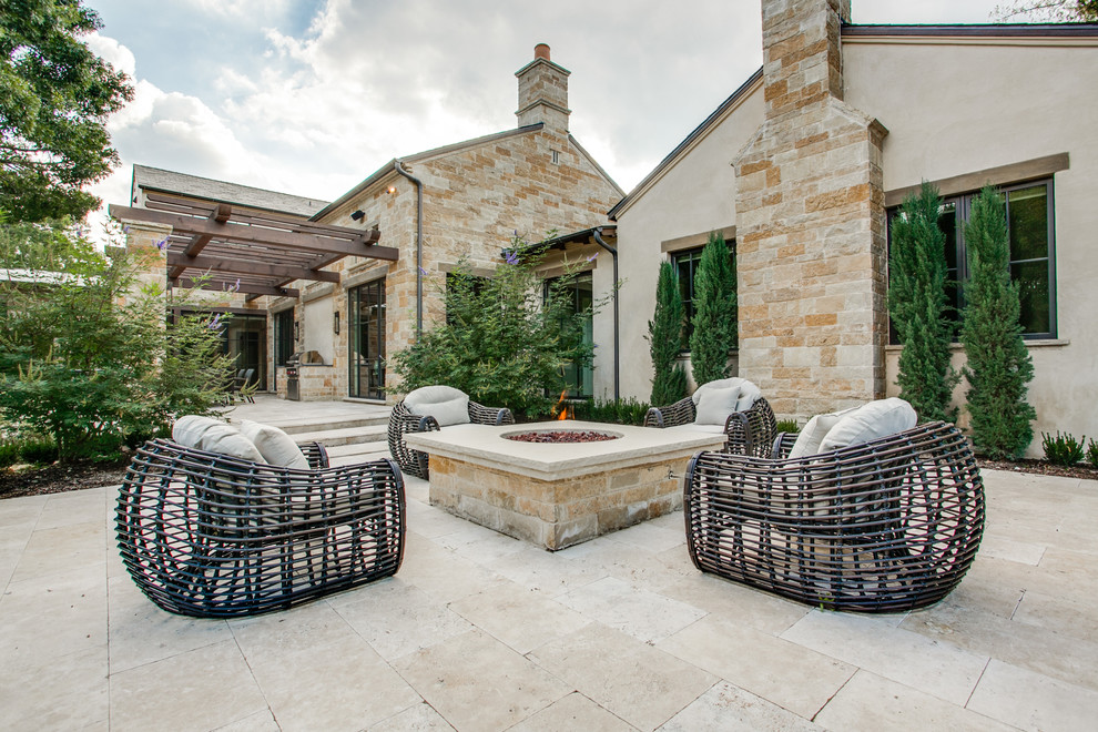Mediterranean patio in Dallas with a fire feature and no cover.