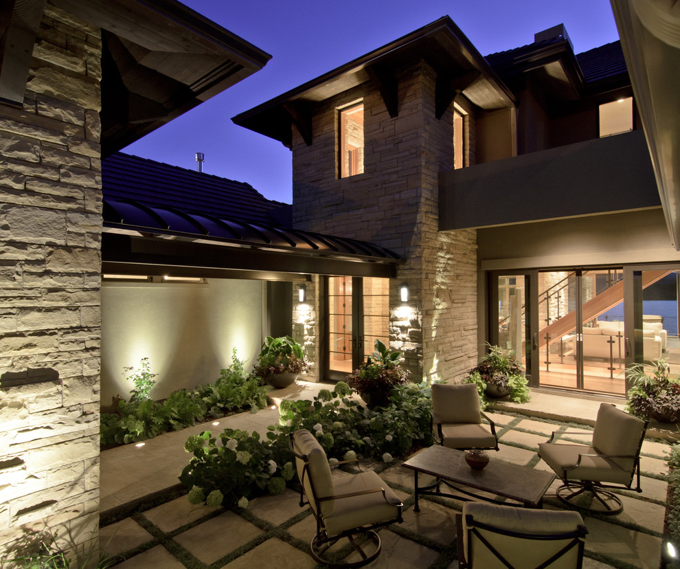 This is an example of a medium sized traditional patio in Denver with natural stone paving.