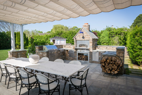 Enhance Outdoor Appeal with Grey Marble Countertops on a Stone Veneer Kitchen Deck
