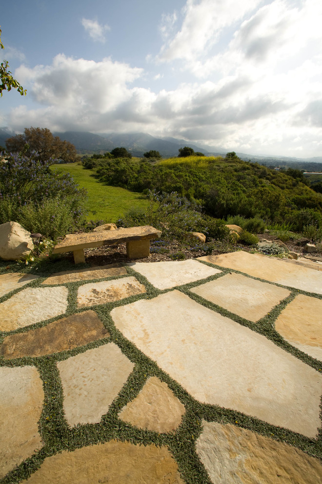 Inspiration for a mediterranean stone patio remodel in San Luis Obispo with no cover