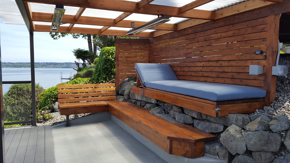 Photo of a small nautical back patio in Seattle with decking and an awning.