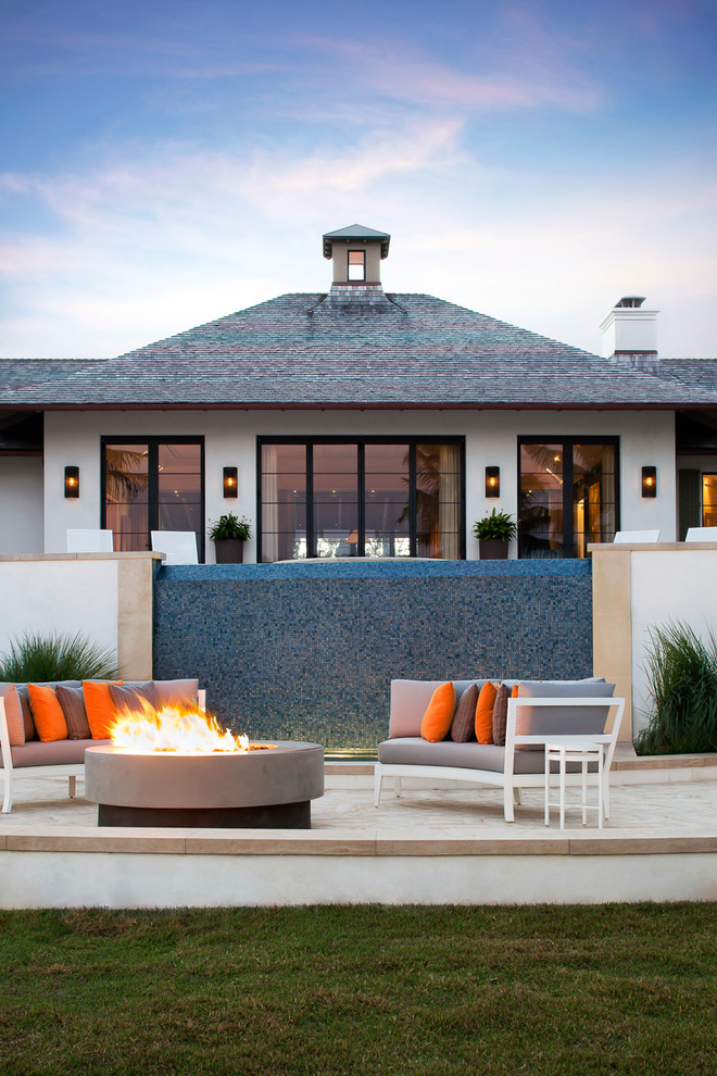 World-inspired patio in Miami with a fire feature.
