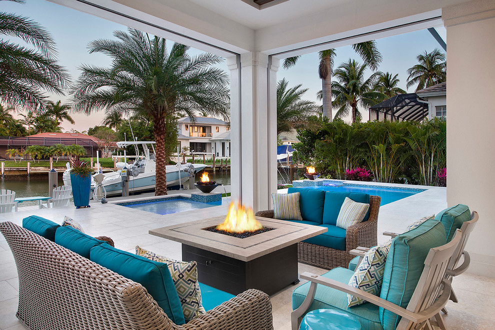 Design ideas for a coastal patio in Miami with a fire feature.