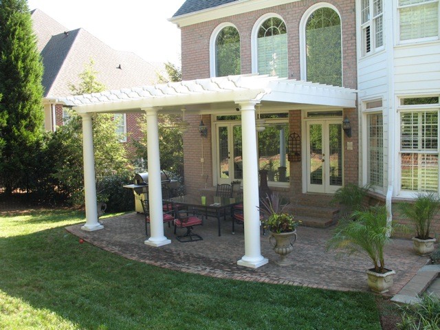 Medium sized modern back patio in Seattle with an outdoor kitchen, brick paving and a pergola.
