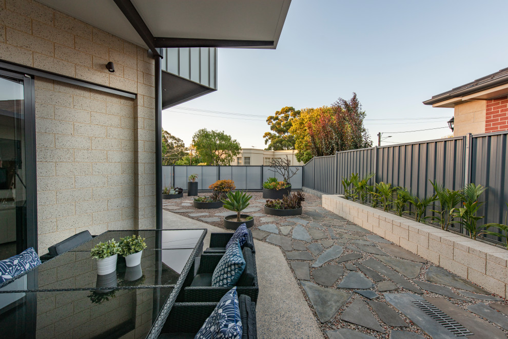 Mittelgroßer Eklektischer Patio hinter dem Haus mit Kübelpflanzen, Betonplatten und Markisen in Adelaide