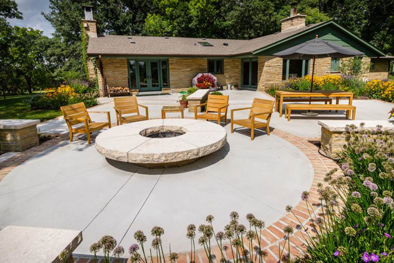 Patio - mid-sized 1950s backyard concrete paver patio idea with a fire pit