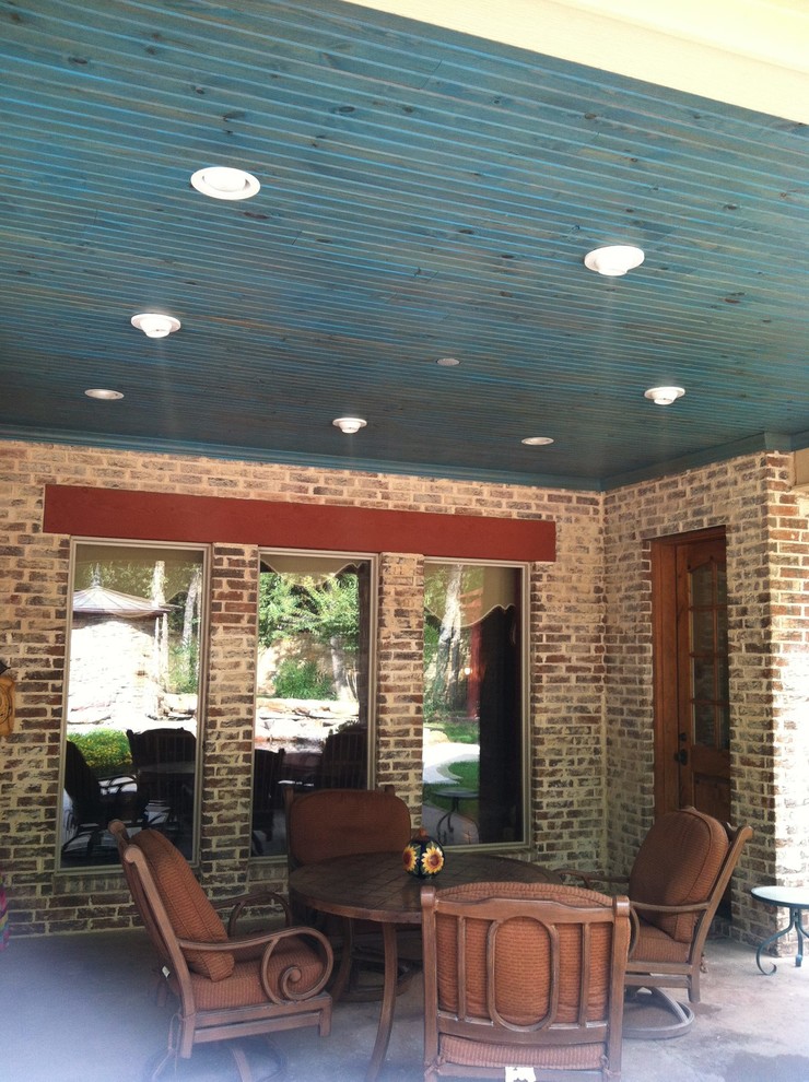 Inspiration for a small timeless backyard concrete patio remodel in Dallas with a roof extension
