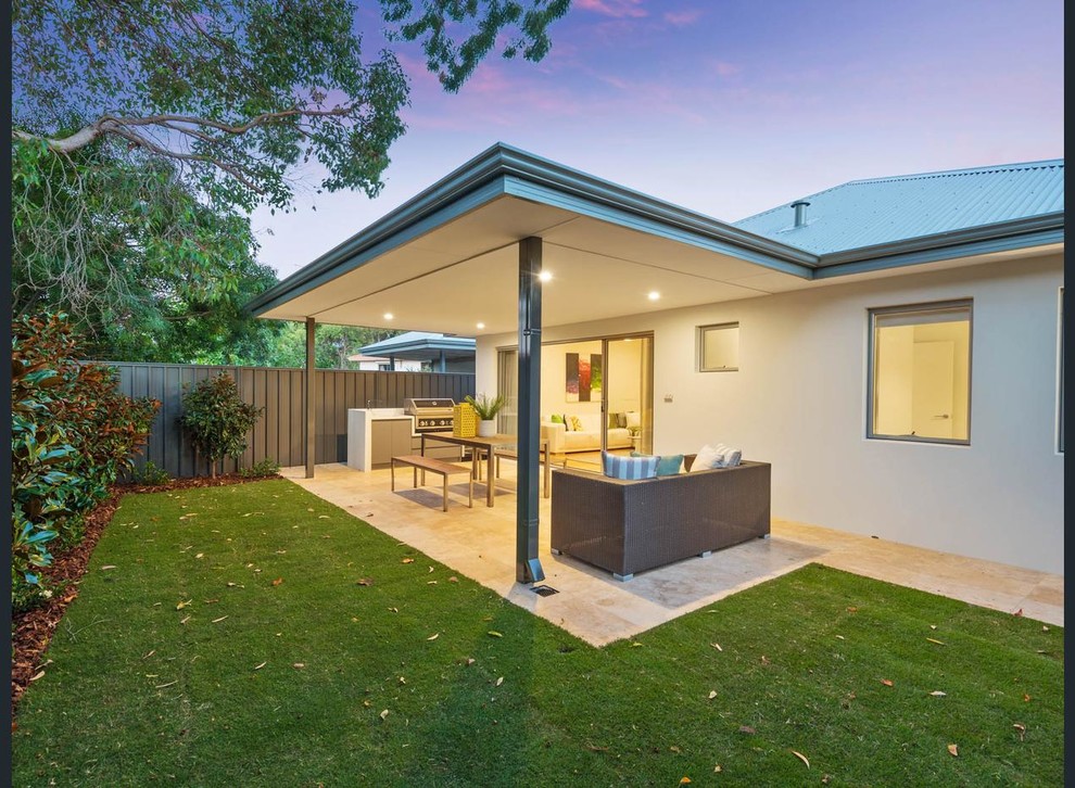 Example of a mid-sized minimalist backyard tile patio design in Perth with a roof extension