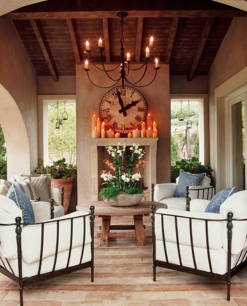 Patio - mediterranean patio idea in Orange County with a fire pit and a roof extension