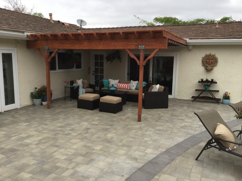 Inspiration for a medium sized contemporary back patio in Los Angeles with an outdoor kitchen, brick paving and a pergola.
