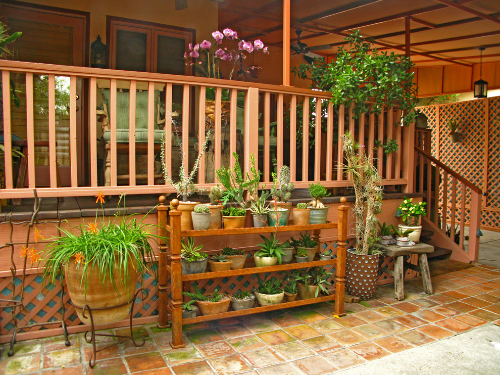 Design ideas for a medium sized bohemian courtyard patio in Los Angeles with a potted garden, tiled flooring and no cover.