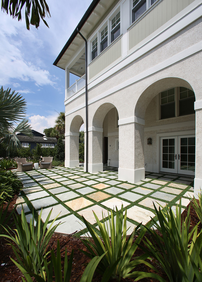 This is an example of a world-inspired patio in Tampa with no cover.