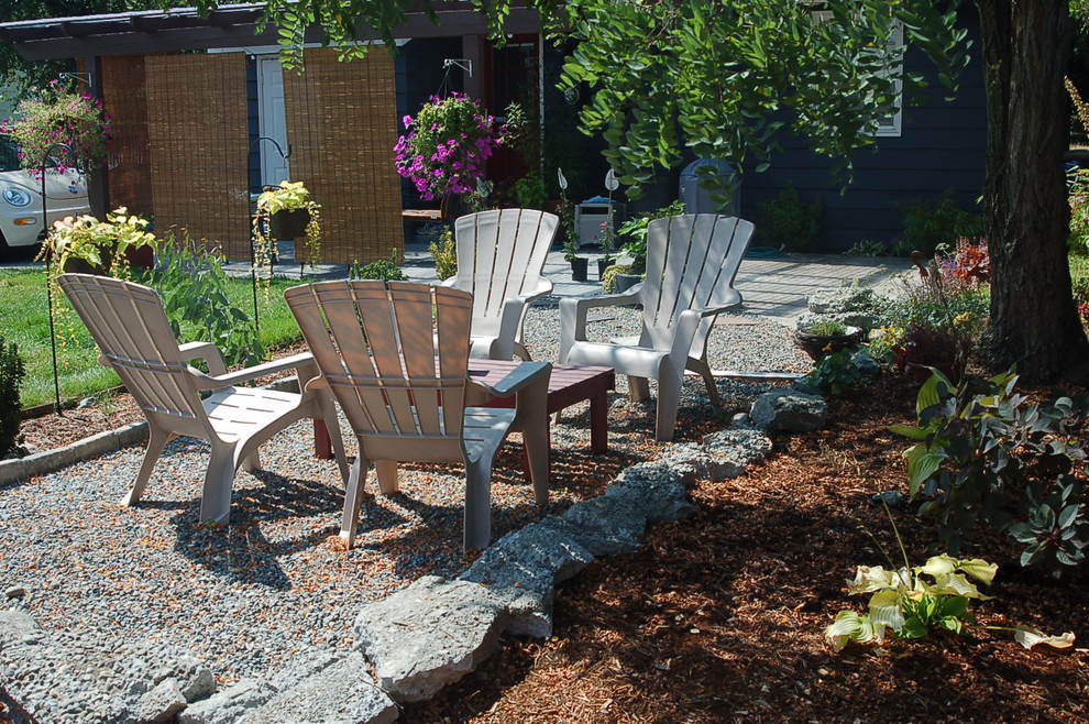Photo of an eclectic patio in Seattle with gravel and no cover.