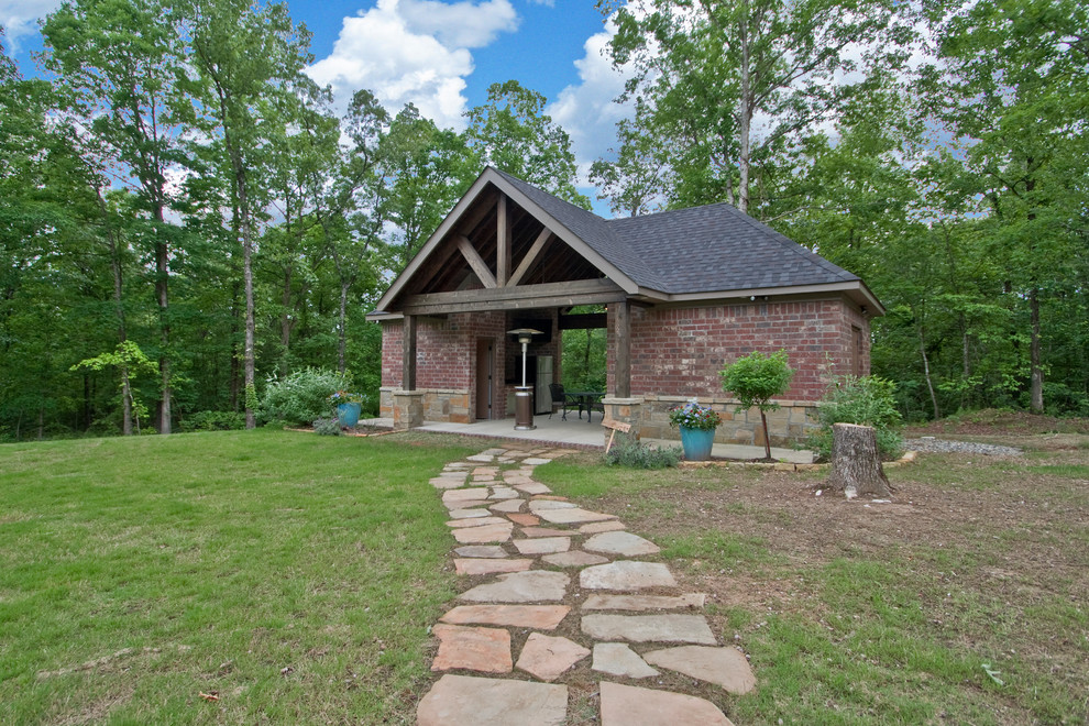 Large rustic back patio in Little Rock with natural stone paving and a gazebo.