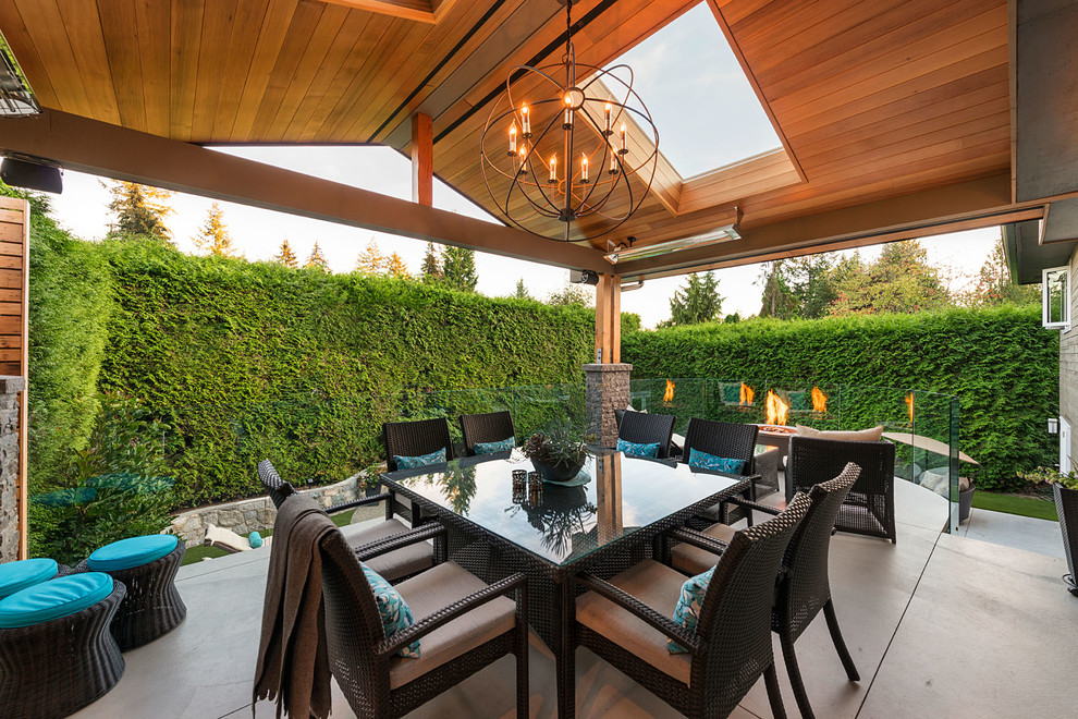 Large transitional backyard concrete patio photo in Vancouver with a fire pit and a pergola