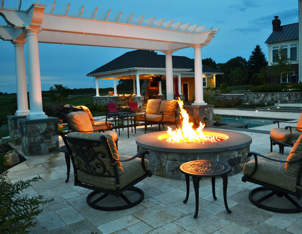 Photo of a modern patio in DC Metro with a fire feature and natural stone paving.