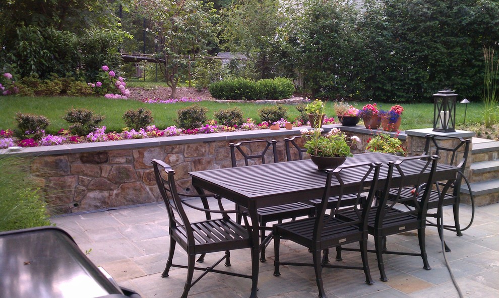 Inspiration for a small timeless backyard stone patio remodel in DC Metro