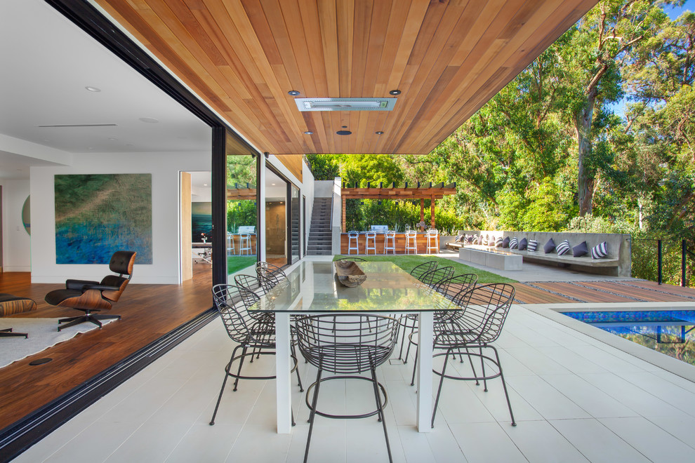 Patio - contemporary patio idea in Los Angeles with a roof extension