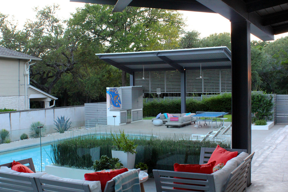 Inspiration for a large modern backyard concrete patio remodel in Austin with a gazebo