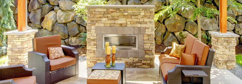 Inspiration for a medium sized classic back patio in Boston with a fire feature, natural stone paving and a pergola.