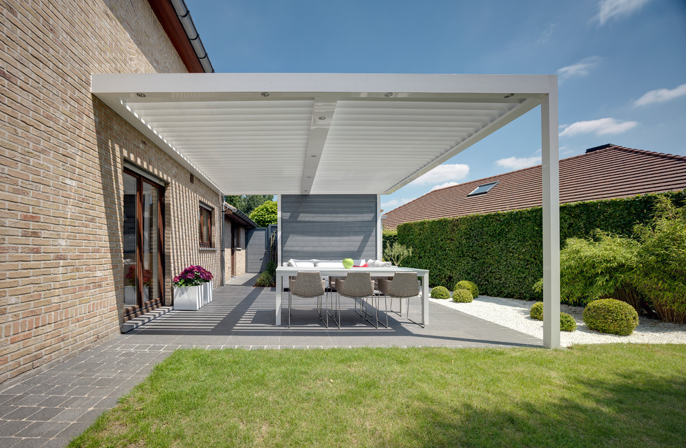 Photo of a contemporary back patio in Buckinghamshire with a pergola.