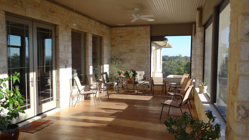 Design ideas for a large classic back patio in Austin with a living wall, concrete slabs and a roof extension.