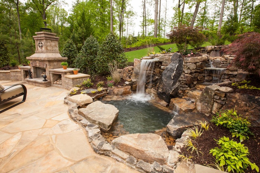 Patio fountain - huge transitional backyard stone patio fountain idea in Atlanta with no cover