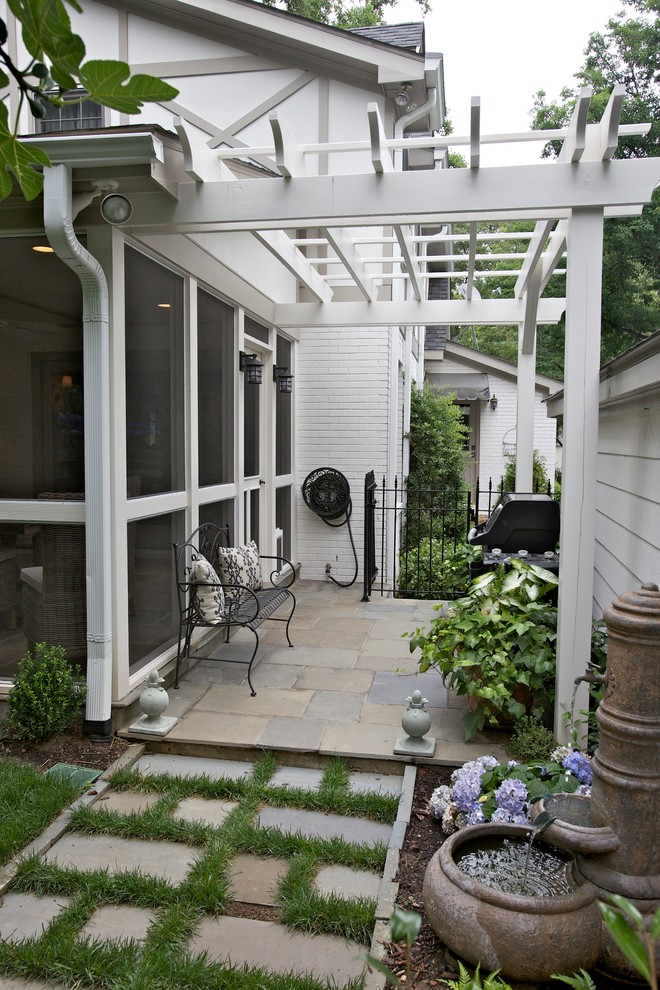 Inspiration for a traditional patio in Raleigh with a pergola and a water feature.