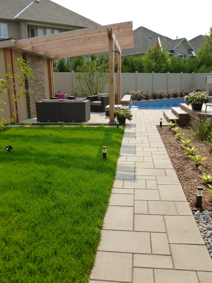 Design ideas for a contemporary back patio in Ottawa with concrete paving.