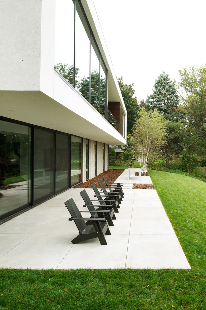 Ispirazione per un patio o portico minimalista con lastre di cemento e nessuna copertura