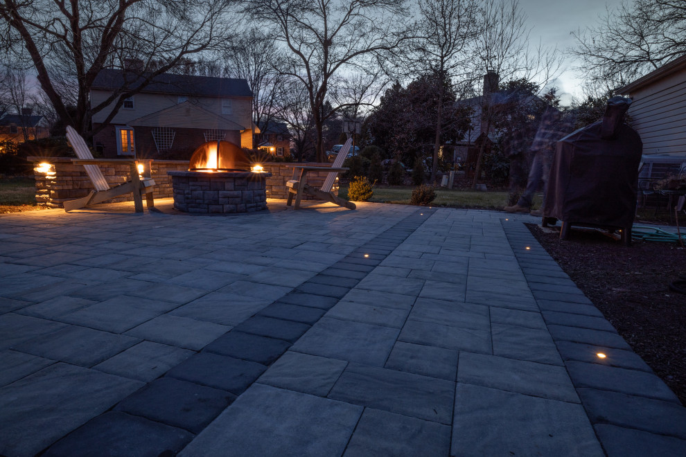 Medium sized modern back patio in Wilmington with a fire feature and concrete paving.