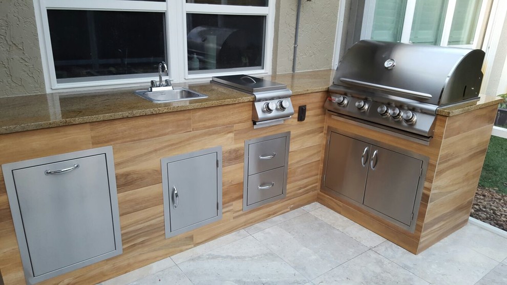 Photo of a small modern back patio in Miami with an outdoor kitchen.