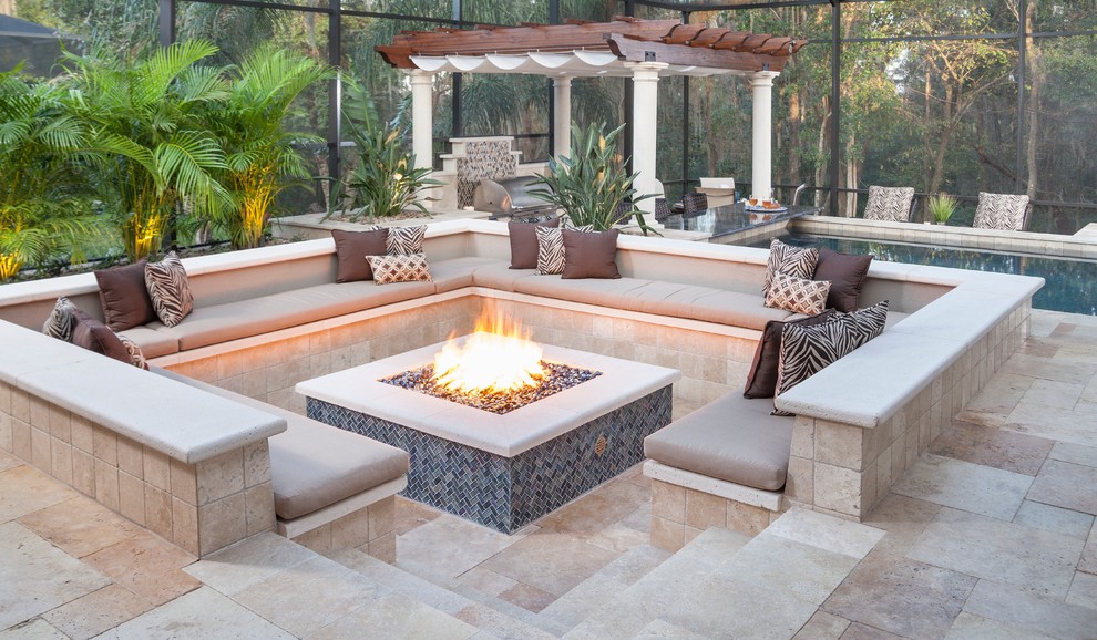 Design ideas for a medium sized traditional back patio in Tampa with a fire feature, natural stone paving and a pergola.