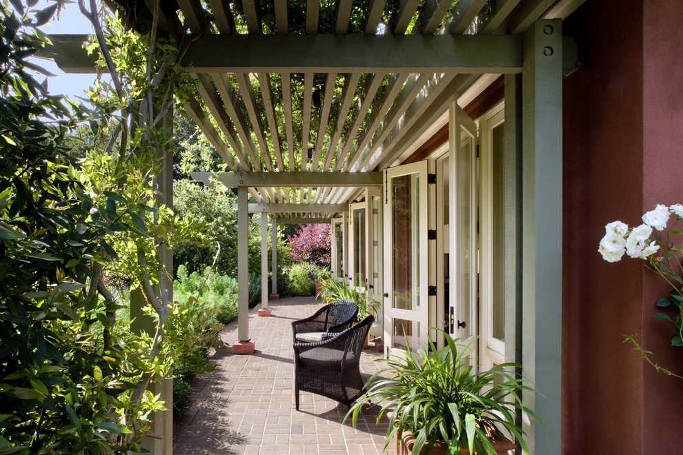 Inspiration for a timeless brick patio remodel in San Francisco with a pergola