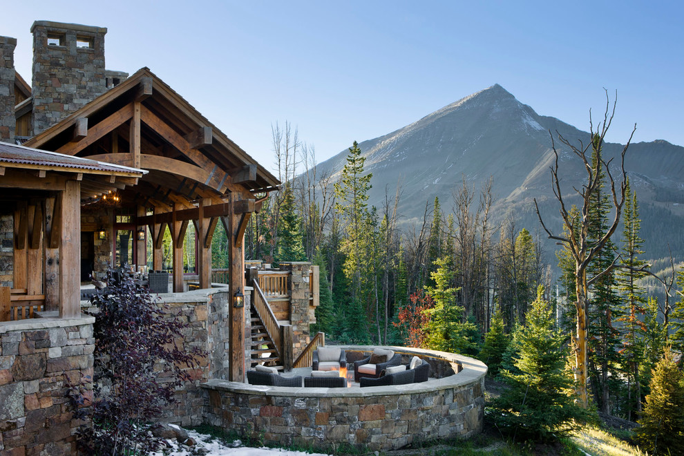 Example of a mountain style patio design in Other with a fire pit and no cover