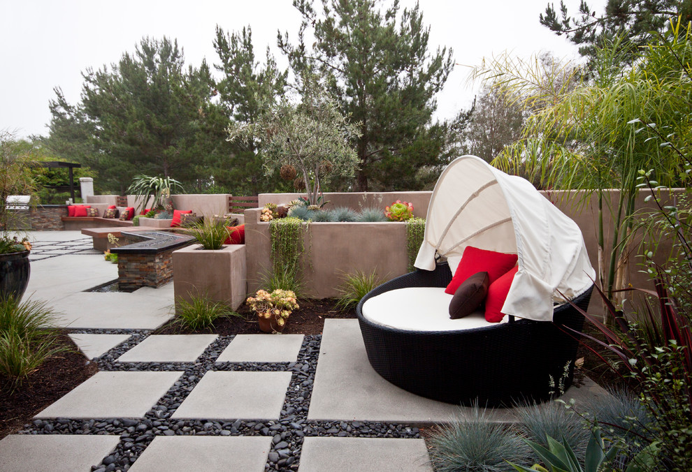 This is an example of a small contemporary back patio in San Diego with a water feature, concrete paving and no cover.