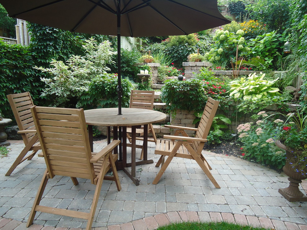 Small elegant courtyard brick patio photo in Toronto with no cover