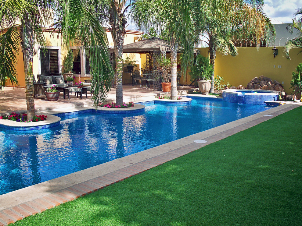 Inspiration for a large timeless backyard concrete and custom-shaped pool remodel in Other