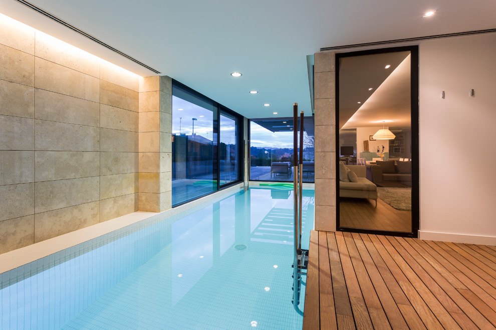 Inspiration for a medium sized contemporary indoor rectangular swimming pool in Other with decking and a pool house.