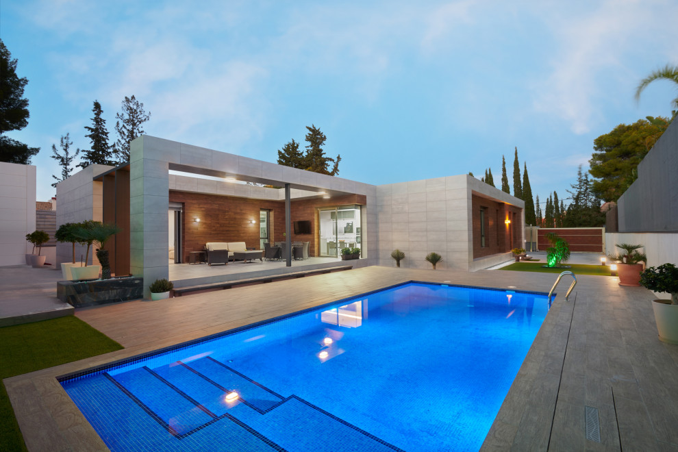 Стильный дизайн: прямоугольный бассейн в современном стиле с покрытием из плитки - последний тренд