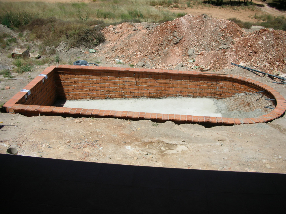 This is an example of a large rural back private and custom shaped lengths swimming pool in Other with tiled flooring.