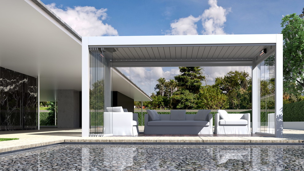 Inspiration för en mellanstor funkis rektangulär infinitypool på baksidan av huset, med stämplad betong