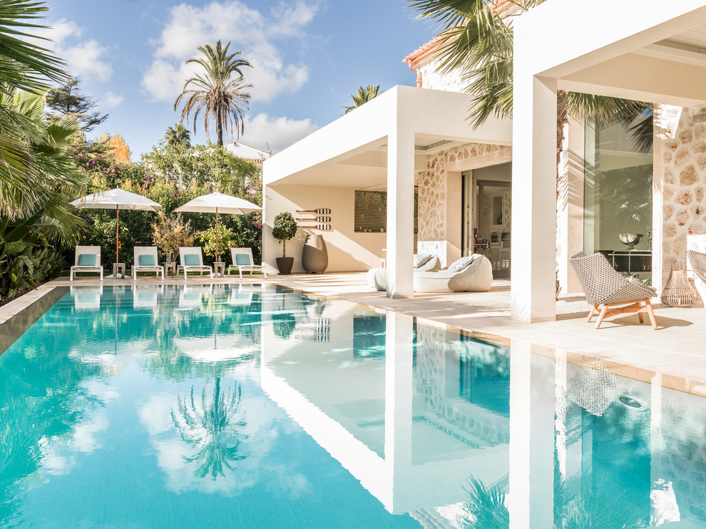 Pool house - large coastal backyard rectangular lap pool house idea in Palma de Mallorca